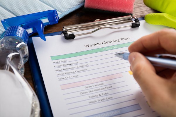 A cleaning schedule being filled out ensuring the entire home is clean